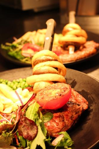 a plate of food with meat and vegetables on a table at The Moorland Hotel in Wotter