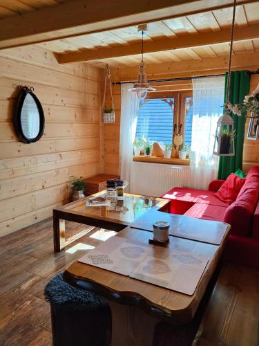 a living room with a red couch and a table at U Dziadka in Chochołów