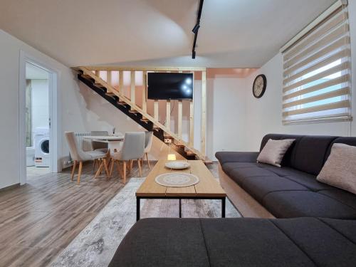 a living room with a couch and a table at Apartmani Gala Žabljak in Žabljak