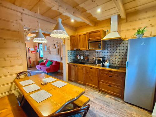 a kitchen with a wooden table and a refrigerator at U Dziadka in Chochołów