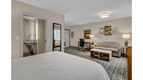 a hotel room with a bed and a desk at Staybridge Suites Salt Lake-West Valley City by IHG in West Valley City