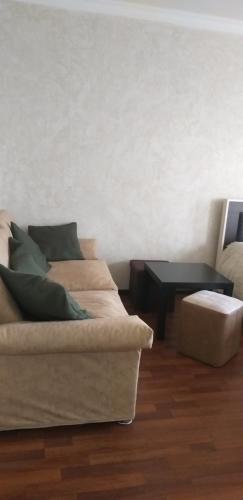 a living room with a couch and a table at Apartment in Poti in Poti