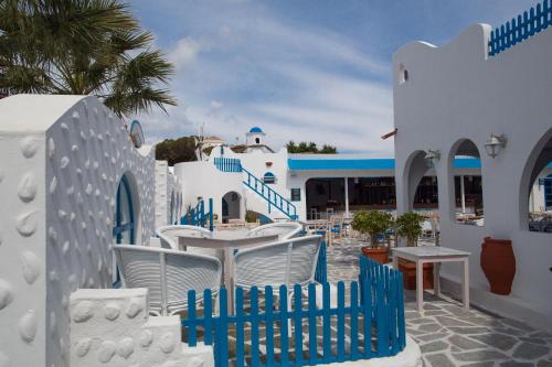 a blue and white building with a table and chairs at Romantza Mare in Kallithea Rhodes