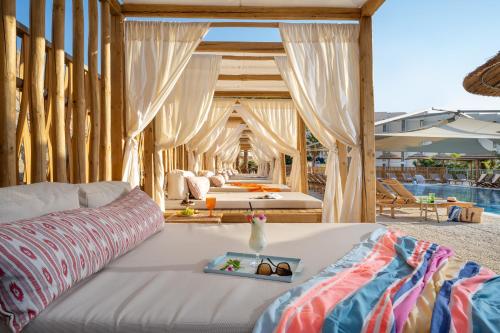 a living room with a couch and a bed at Oasis Spa Club Dead Sea Hotel - 18 Plus in Ein Bokek