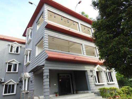 a building with a large window on the side of it at Lake Side Resort Neermahal in Melāghar