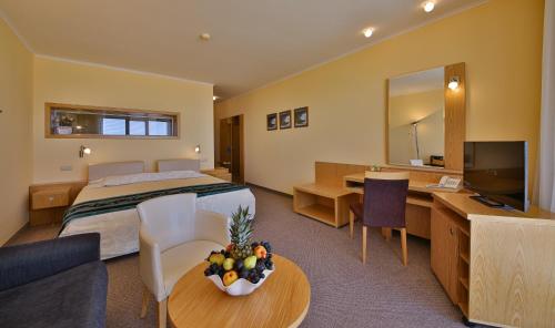 a hotel room with a bed and a desk and a television at Kaliakra Beach Hotel - Ultra All Inclusive in Albena