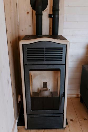 an old stove sitting on the floor in a room at Somnium Pieniny in Tylka