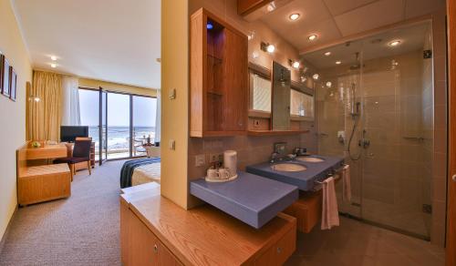 a bathroom with two sinks and a shower at Kaliakra Beach Hotel - Ultra All Inclusive in Albena