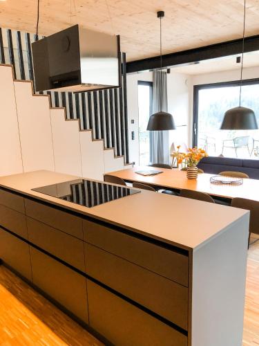 a kitchen with a staircase in a house at Sauerland Lodge - Haus Anton in Winterberg