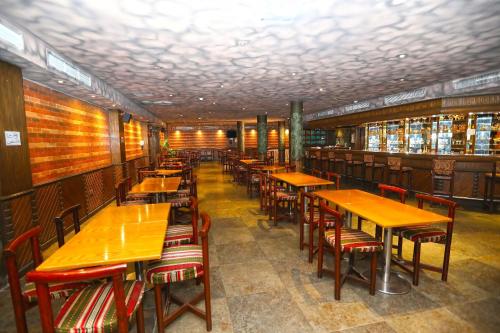 a row of tables and chairs in a restaurant at Sea Shell Hotel in Manama