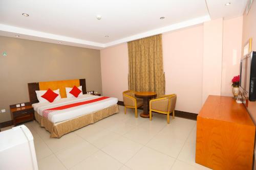a hotel room with a bed and a table at Sea Shell Hotel in Manama