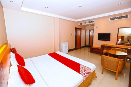a hotel room with a bed and a desk at Sea Shell Hotel in Manama