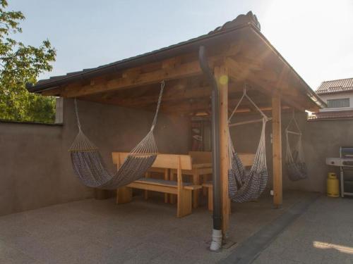 a patio with two hammocks under a canopy at Holiday Home Thesaurum in Karanac
