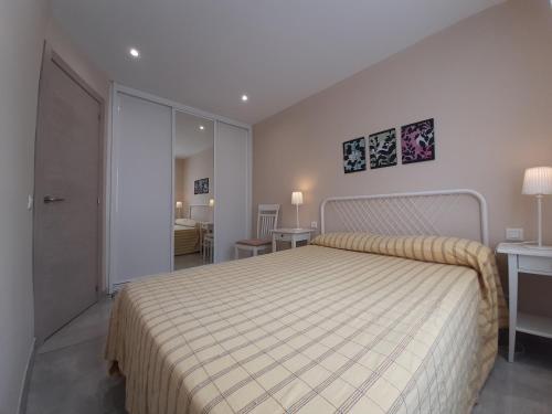 a bedroom with a large bed with a white bedspread at Lo de Jaime in Arriondas