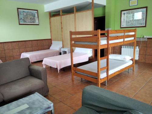 a living room with two bunk beds and a couch at A CONDA in Arzúa