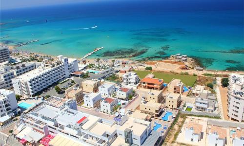 an aerial view of a city and the ocean at Seafront Protaras Villas in Protaras