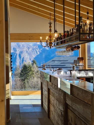 a bar with a view of the mountains at Rifugio Baita Motti in Domodossola
