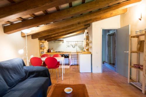 a living room with a blue couch and red chairs at Can Petitu in Amer