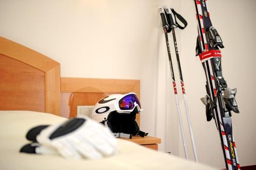 a room with skis and a helmet on a bed at HELI'S Bed & Breakfast in Saalbach Hinterglemm