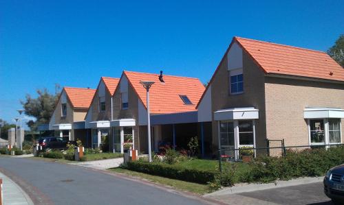 a row of houses with orange roofs on a street at Dormio Resort Berck-sur-Mer in Berck-sur-Mer