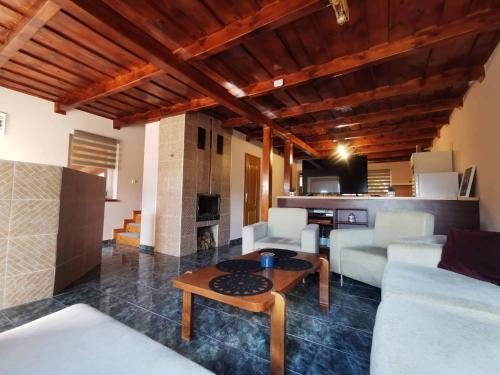 a living room with a couch and a table at Garden Vendégház Velence in Velence