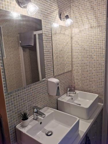 a bathroom with a sink and a mirror at Garden Vendégház Velence in Velence
