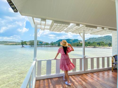 a woman in a pink dress standing on a boat at Morelo Water Villa in Batam Center