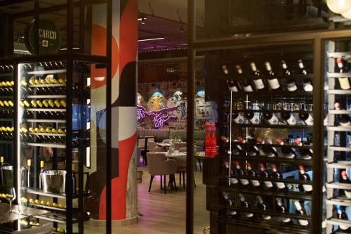 a room with a lot of bottles of wine at The Rockefeller Hotel by NEWMARK in Cape Town