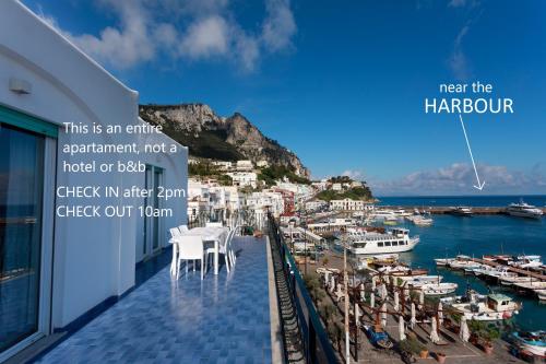 a hotel balcony with a view of a harbor at Capri holiday home with a sea view in Capri