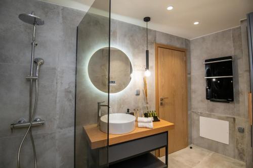 a bathroom with a sink and a shower at Casa Teo, By Hellocrete in Spílion