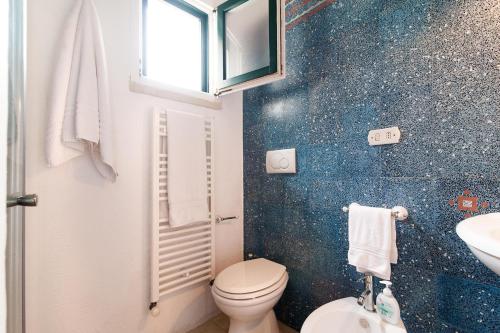 a bathroom with a toilet and a sink at Tenuta Aphrodite in Racale