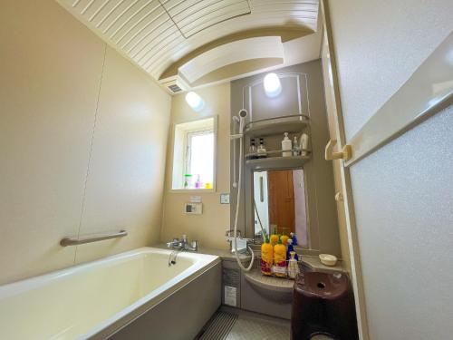 a bathroom with a tub and a sink at Crane in Kushiro
