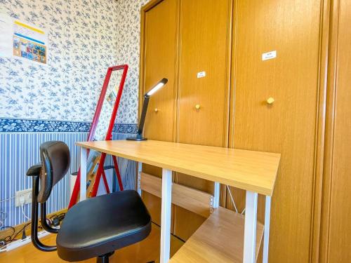 a desk and a chair next to a cabinet at Crane in Kushiro