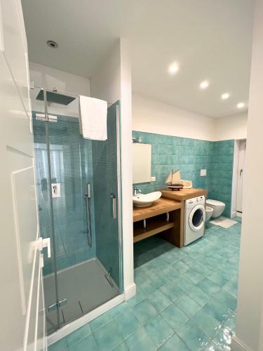 a bathroom with a shower and a washing machine at Luxury Villa Relax in Ischia Town