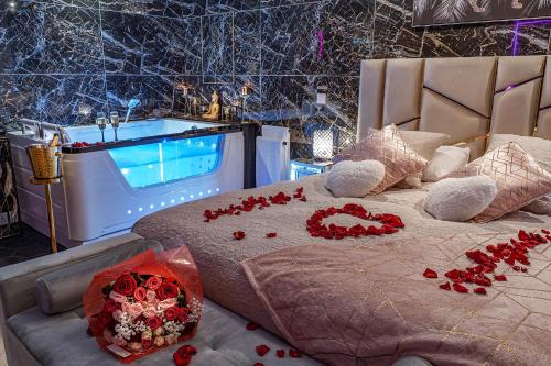 a bedroom with a bed with red roses on it at Magnifique loft / spa en face de la cathédrale ! in Narbonne