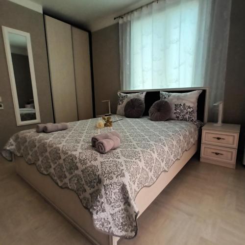 a bedroom with a bed with pink pillows on it at Baltā Studio with Patio & Free Parking in Ventspils