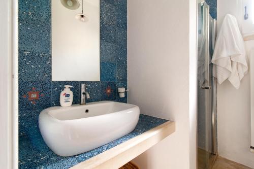 a bathroom with a white sink and a mirror at Tenuta Aphrodite in Racale