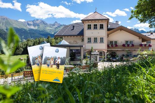 a house with a sign in front of it at ALPENAPART LADIS ehemals Alpenapart Alexander in Ladis