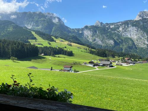 a green field with mountains in the background at Haus Sperleiten in Abtenau