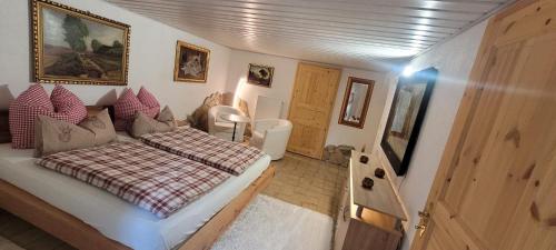 a bedroom with a bed with a red and white blanket at Jägerhaus in Nossen