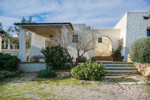 a house with a porch and stairs in front of it at Tenuta Aphrodite in Racale