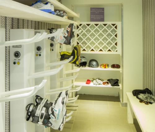 a walk in closet with white shelving at Le Faucigny - Hotel de Charme & SPA in Chamonix-Mont-Blanc