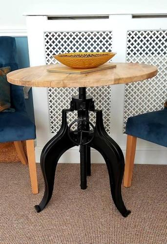 a wooden table with a bowl on top of it at Beautifully appointed, period seaside apartment in Folkestone