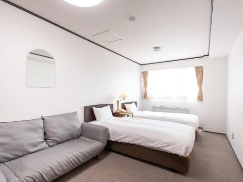 Postel nebo postele na pokoji v ubytování Tabist Hotel New Washington Shibuya