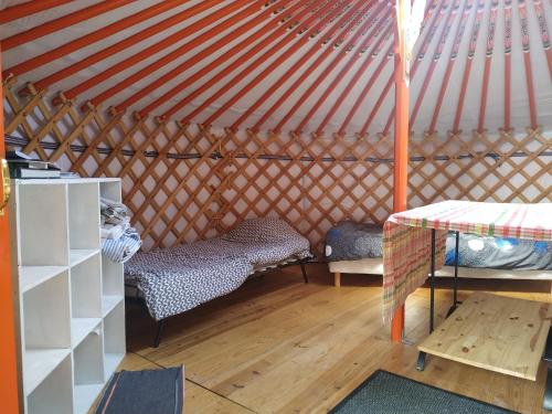 a room with a bed and a table in a yurt at Eco Yourte Lac du Bourget in Conjux