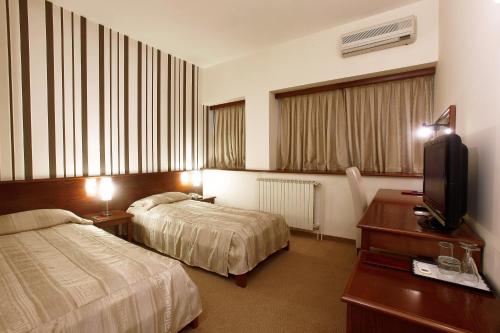 Postel nebo postele na pokoji v ubytování Hotel Centar