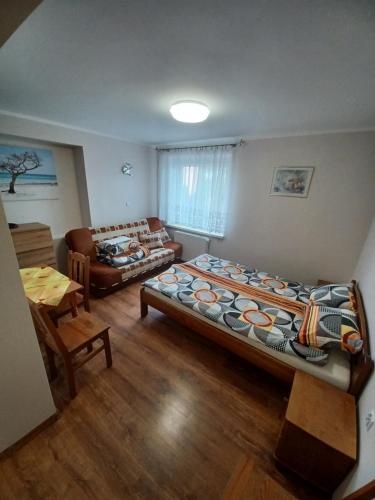 a living room with two beds and a couch at Willa Do-Dar in Krynica Morska