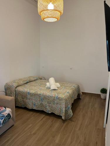 a bedroom with a bed with two pillows on it at Apartamentos El Alcazar de Jerez in Jerez de la Frontera