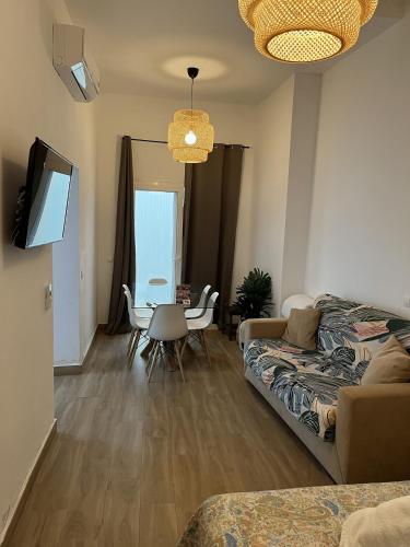 a living room with a couch and a table at Apartamentos El Alcazar de Jerez in Jerez de la Frontera
