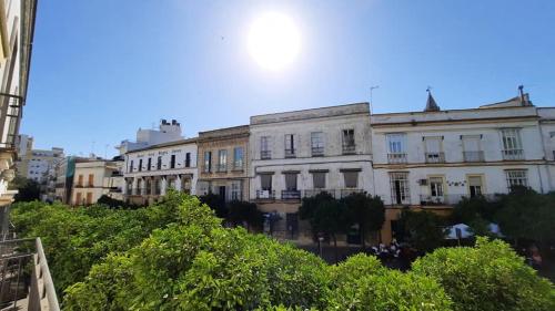 a group of buildings on a city street at Apartamentos El Alcazar de Jerez in Jerez de la Frontera